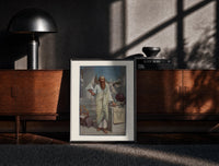 Black-framed Ancient Greek philosopher holding pyramid print on a moody console with designer coffee-table books
