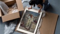 Ancient Greek philosopher holding pyramid framed print being unpacked from protective bubble wrap and a box