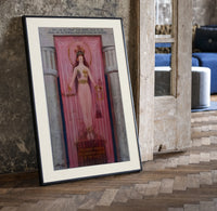 Egyptian goddess Isis unveiled print in a black frame leaning beside a vintage door on parquet