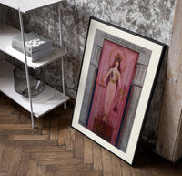 Egyptian goddess Isis unveiled poster in a black frame leaning beside a shelf in a raw-plaster loft
