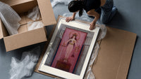 Egyptian goddess Isis unveiled framed print being unpacked from protective bubble wrap and a box