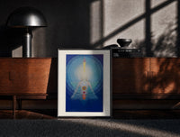 Black-framed Meditating figure with chakra symbols print on a moody console with designer coffee-table books