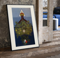 Inverted tree with crown print in a black frame leaning beside a vintage door on parquet