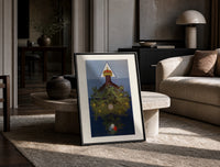 Inverted tree with crown print in a black frame leaning on a travertine table in a sunlit lounge
