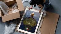 Inverted tree with crown framed print being unpacked from protective bubble wrap and a box