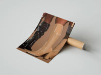 Gently curled Knee-High Boots in Black and Beige print beside its protective shipping tube