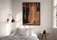 Knee-High Boots in Black and Beige print in a black frame above a bed with striped linens