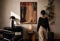 Knee-High Boots in Black and Beige print in a black frame on a sunlit plaster wall, a woman looking on beside a mushroom lamp
