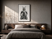 Skeletal samurai in metallic armor poster framed above the bed in a warm minimalist bedroom