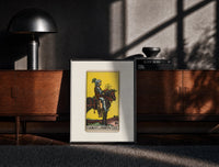 Black-framed Knight on horse holding pentacle print on a moody console with designer coffee-table books