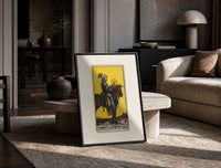 Knight on horse holding pentacle print in a black frame leaning on a travertine table in a sunlit lounge