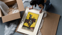 Knight on horse holding pentacle framed print being unpacked from protective bubble wrap and a box
