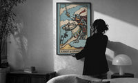 Knight of Swords print in a slim black frame being hung on a sunlit wall in a monochrome room