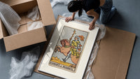 Knight riding horse holding wand framed print being unpacked from protective bubble wrap and a box
