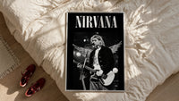 Kurt Cobain Nirvana Live framed print styled on a bed with sneakers alongside