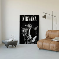 Kurt Cobain Nirvana Live poster framed above a tan leather living-room couch