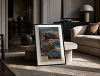 French Riviera coastal railway scene print in a black frame leaning on a travertine table in a sunlit lounge