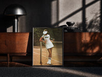 Black-framed Lacoste vintage tennis print on a moody console with designer coffee-table books