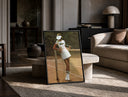 Lacoste vintage tennis print in a black frame leaning on a travertine table in a sunlit lounge