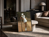 Lacoste vintage tennis print in a black frame leaning on a travertine table in a sunlit lounge