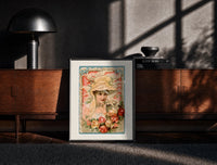 Black-framed Victorian woman in bonnet with flowers print on a moody console with designer coffee-table books