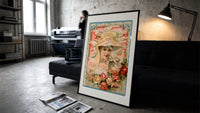Victorian woman in bonnet with flowers print in a slim black frame leaning on a dark sofa in a concrete print studio