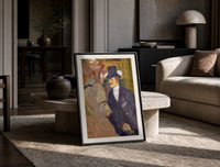 Man in top hat with women print in a black frame leaning on a travertine table in a sunlit lounge