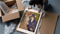 Man in top hat with women framed print being unpacked from protective bubble wrap and a box