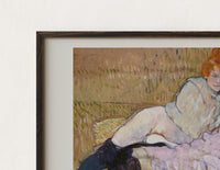 Close-up of the Two reclining women on sofa print's dark wood frame corner and archival matte paper