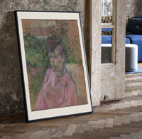 Woman in pink dress portrait print in a black frame leaning beside a vintage door on parquet