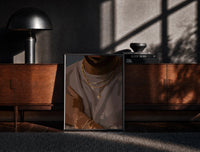Black-framed Layered Gold Chains on Taupe print on the floor in front of a dark wooden console
