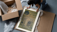 Vintage French soap advertisement with cat framed print being unpacked from protective bubble wrap and a box