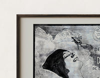 Close-up of the Woman's face with flowing hair reclining print's dark wood frame corner and archival matte paper