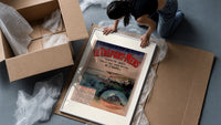 Coastal seaside town harbour view framed print being unpacked from protective bubble wrap and a box