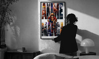 Anime hero collage in giant letters print in a slim black frame being hung on a sunlit wall in a monochrome room