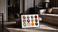 Leopard 8 Ball Circle Collage print in a black frame leaning on a rug beside a beige sofa