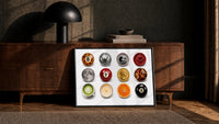 Leopard 8 Ball Circle Collage print in a black frame leaning against a walnut sideboard