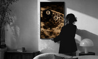 Leopard and Black 8 Balls print in a slim black frame being hung on a sunlit wall in a monochrome room