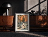 Black-framed winter sports scene with sledders and skiers print on a moody console with designer coffee-table books