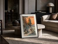 Winter sports scene with sledders and skiers print in a black frame leaning on a travertine table in a sunlit lounge