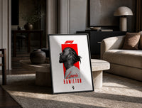 Lewis Hamilton profile portrait print in a black frame leaning on a travertine table in a sunlit lounge