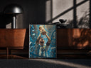Black-framed Footballer lifting World Cup trophy print on a moody console with designer coffee-table books