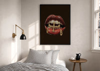 Lips with a Cross and Grillz print in a black frame above a bed with striped linens, a brass wall lamp and a sunlit window