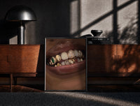 Black-framed Lips with Decorative Gold Grillz print on the floor in front of a dark wooden console