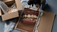 Lips with Decorative Gold Grillz framed print being unpacked from protective bubble wrap and a box