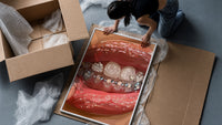 Rows of Tooth Gems framed print being unpacked from protective bubble wrap and a box