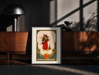 Black-framed Girl witch holding black cat print on a moody console with designer coffee-table books