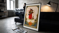 Girl witch holding black cat print in a slim black frame leaning on a dark sofa in a concrete print studio