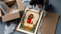 Girl witch holding black cat framed print being unpacked from protective bubble wrap and a box