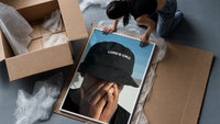Lord's Child Bucket Hat framed print being unpacked from protective bubble wrap and a box
